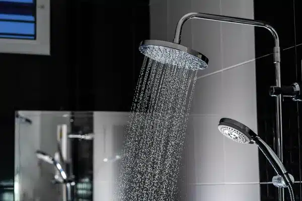Rain shower head in action, showing the wider water flow that sets it apart from a standard handheld shower
